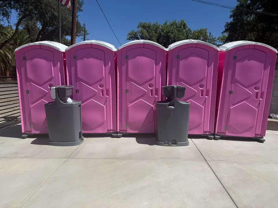 Event porta potties lined up with hand-wash stations for a Tipton gathering