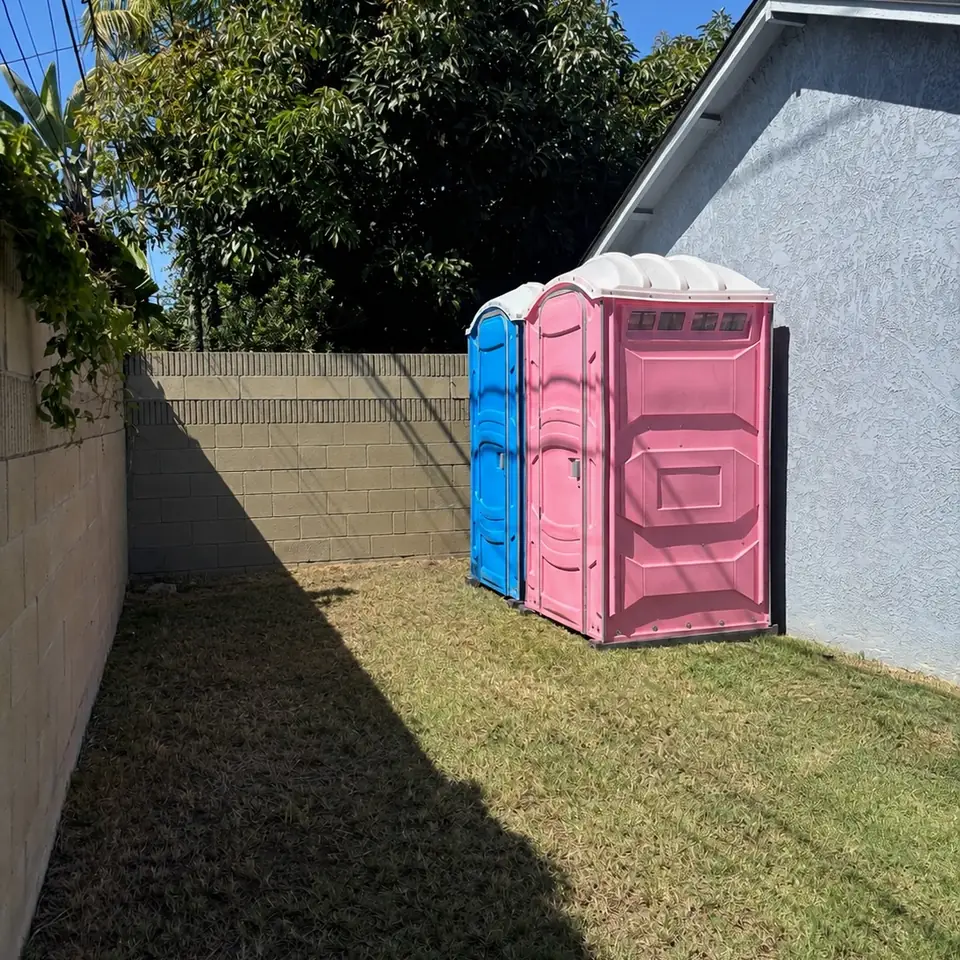 Porta potty set in a grassy side yard, a common Holts Summit backyard placement
