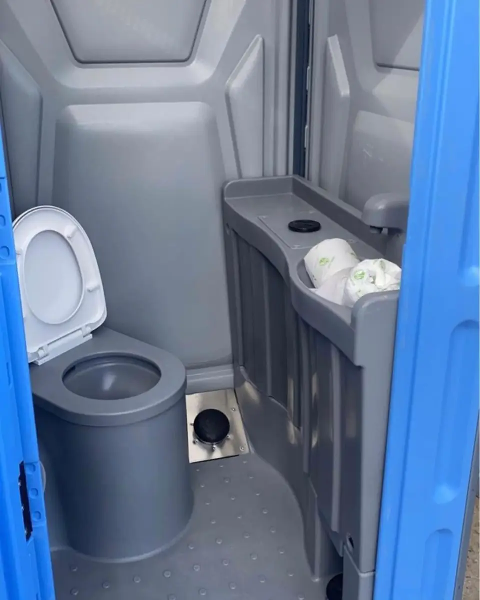 Toilet paper holders mounted inside a standard porta potty