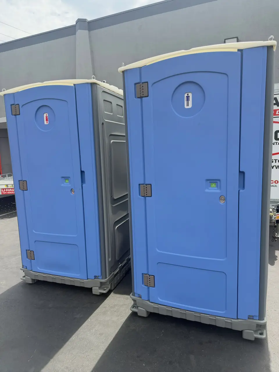 Two clean standard porta potties side by side